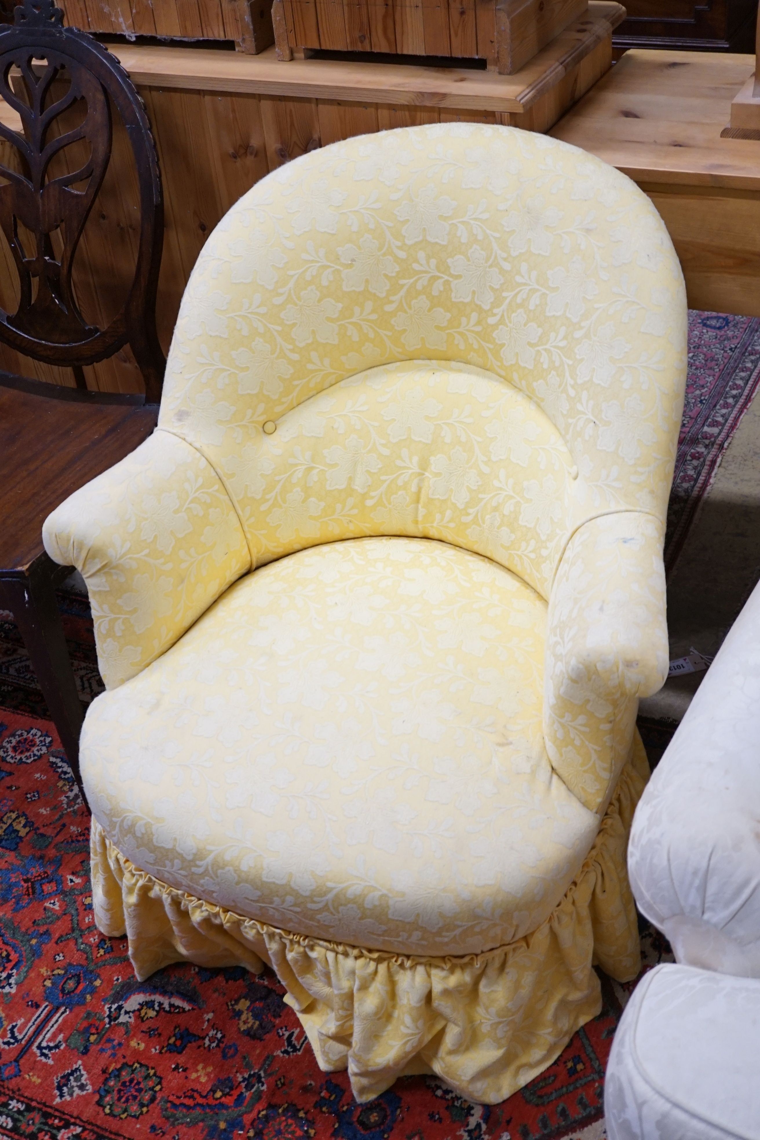 A brown leather upholstered desk chair, a mahogany hall chair and two upholstered armchairs
